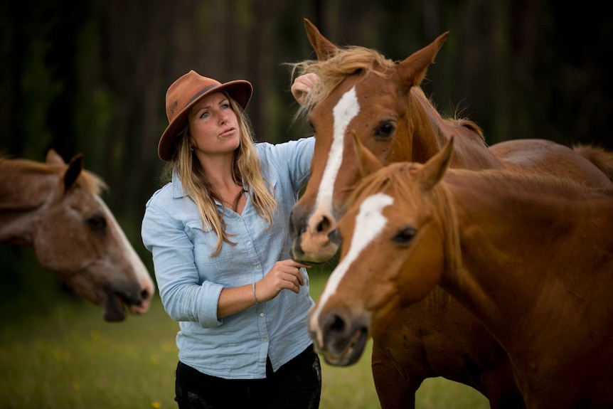 Srisa Heffernan pats a horse.