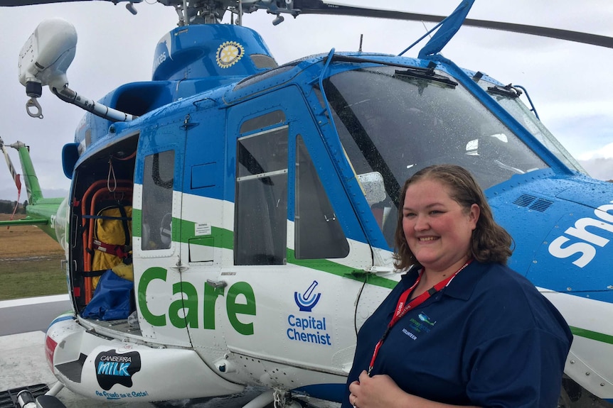 Adrienne Mathews in front of the SouthCare helicopter.