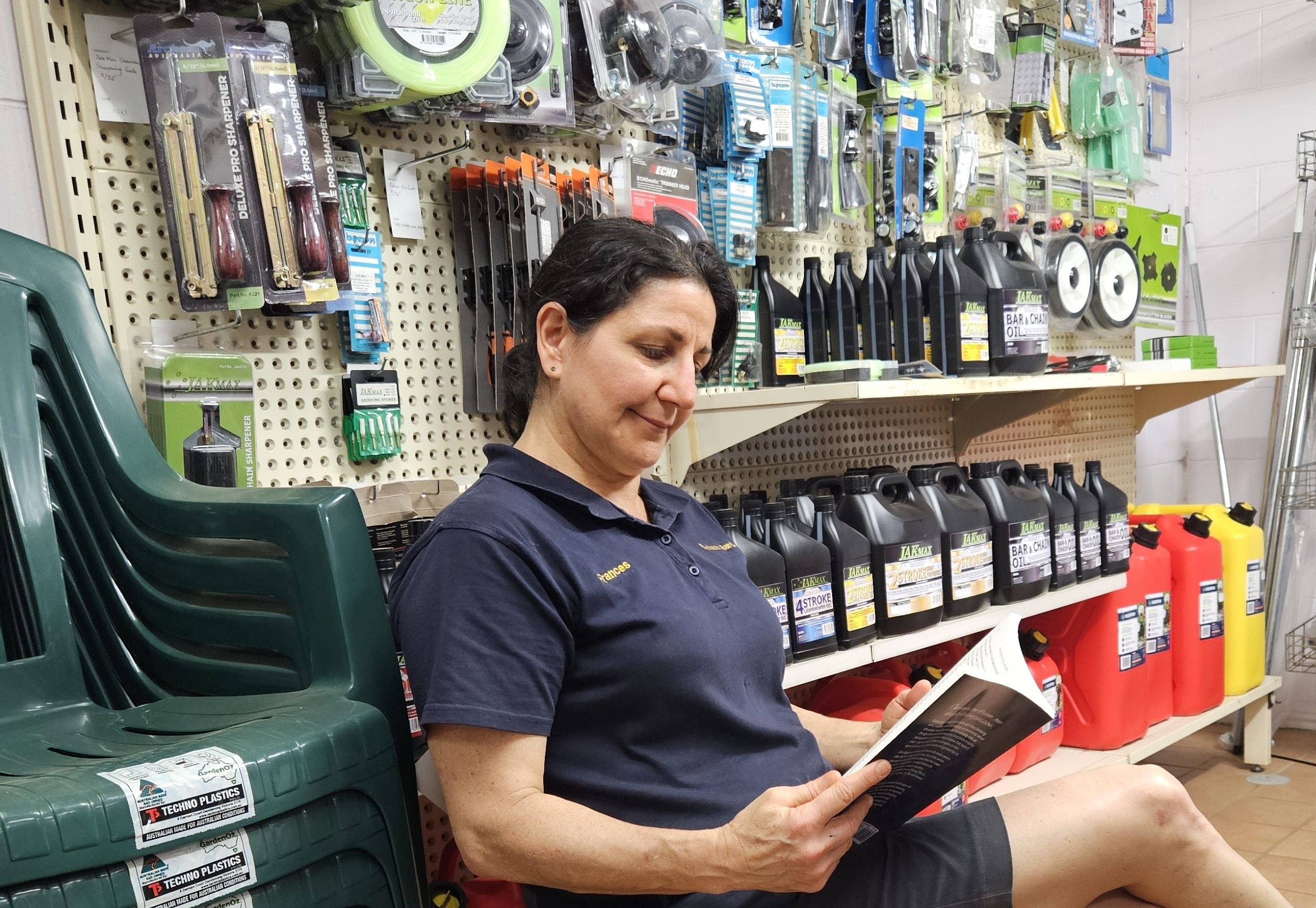 Lady reading a book in a hardware store