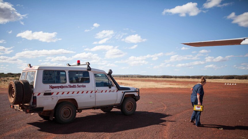 A clinic worker collects a delivery at the Cosmo Newbery airstrip, WA.