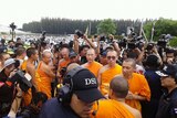 Devotees, monks and Thai authorities outside the Dhammakaya temple.
