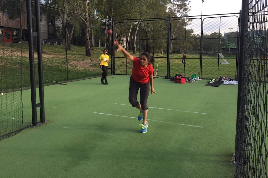 Poongodai Sivam throws ball in nets at the ANU during training for women's cricket club.