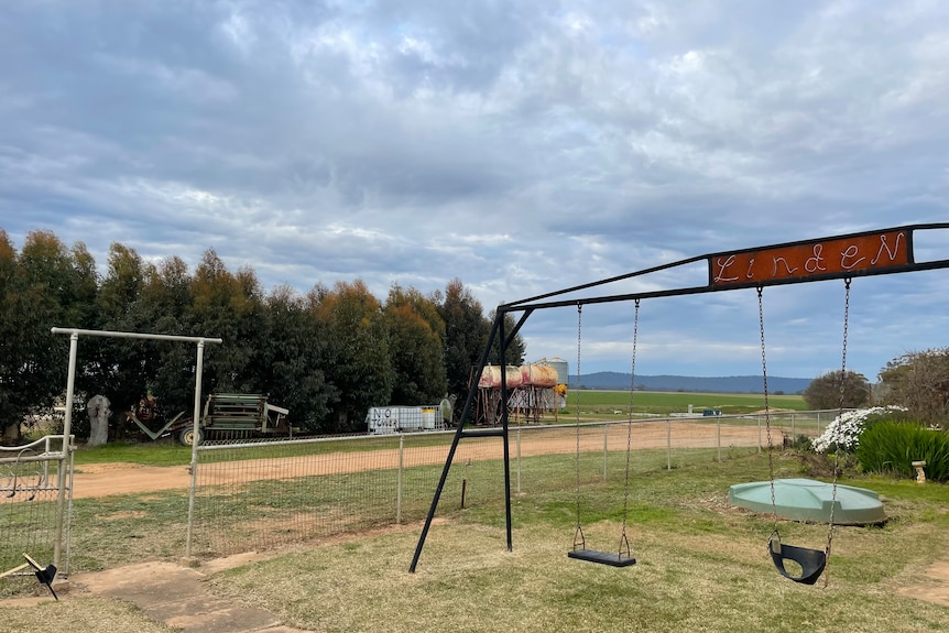 A swing set on a farm.