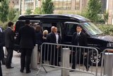 Hillary Clinton is helped into a van.