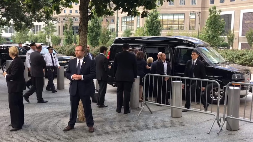 Hillary Clinton is helped into a van.