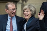 Theresa May and her husband Philip May wave to media and supporters.
