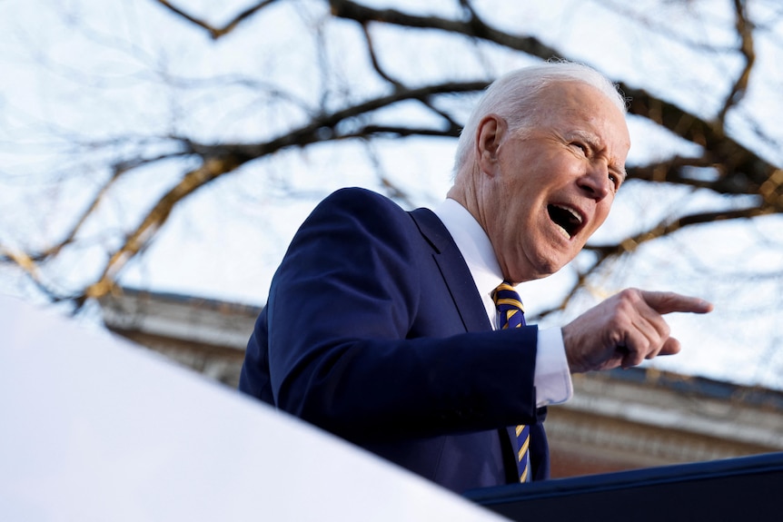 Close up of Joe Biden pointing his finger giving a fiery speech at a podium. 