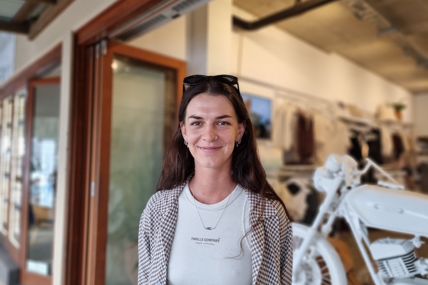 Byron Bay clothing store employee Natalie McGarry standing out the front of a shop she works at.