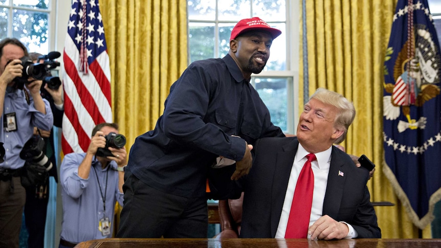 Rapper Kanye West shakes hands with President Donald Trump in the Oval Office of the White House.