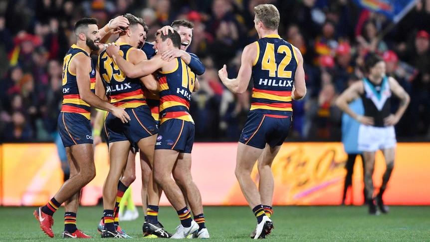 Crows players celebrate their Showdown win over Port Adelaide