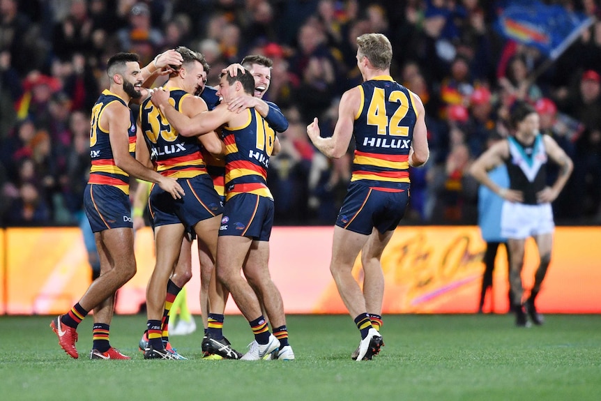 Crows players celebrate their Showdown win over Port Adelaide