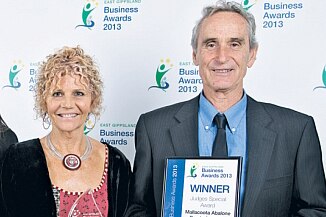 Gerry Menke and Mary Menke winning a Business Award in 2013
