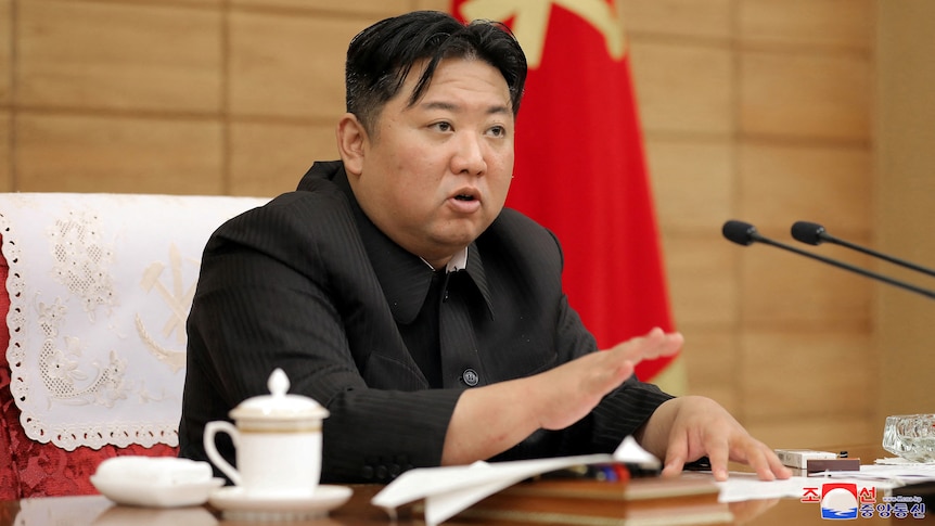 Close up of seated man speaking during meeting.