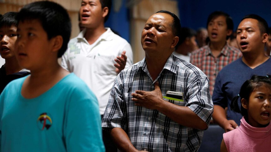 People praying in a church in Thailand