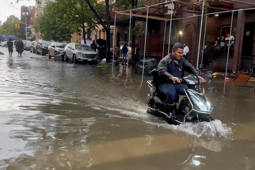 Motorcycle driving through floodwaters.