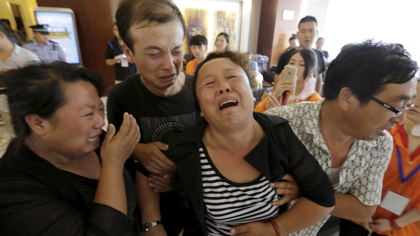 Mother of Tianjin firefighter outside news conference