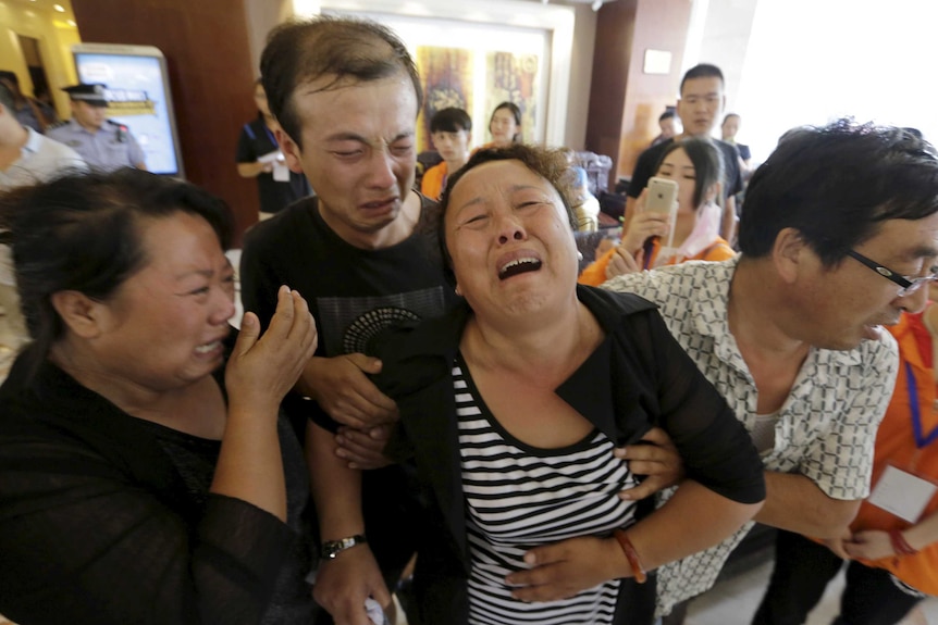 Mother of Tianjin firefighter outside news conference