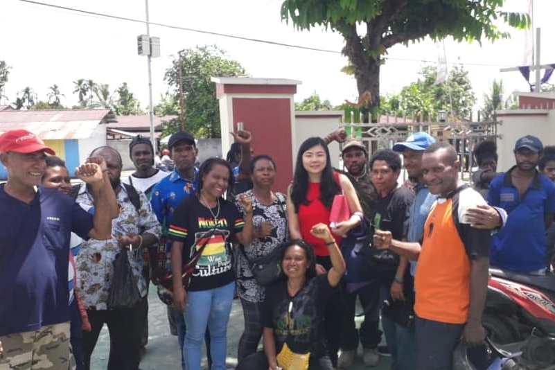 Ms Koman stands with a group of Papuan activists.