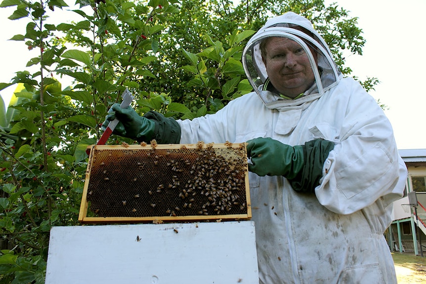 Barry Parkins holding his beehive.