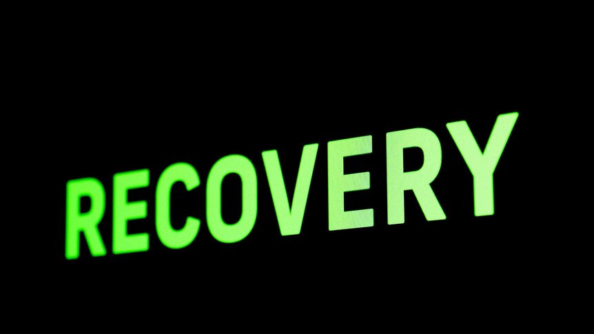 Greens sign saying Recovery on a black background