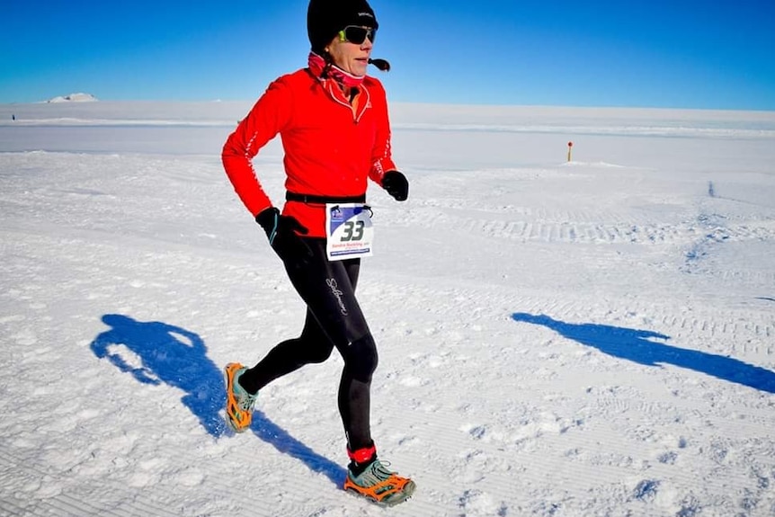 A woman running in Antarctica.