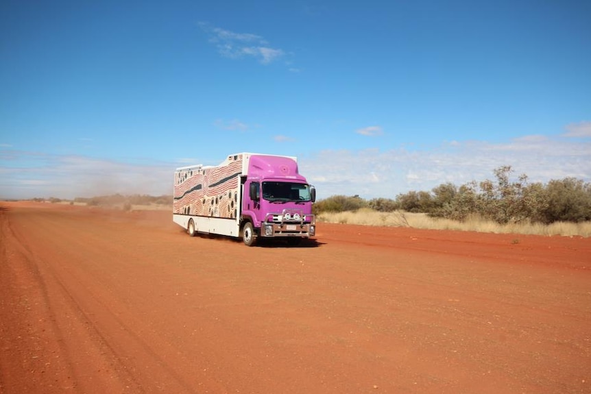 The Purple Truck mobile dialysis unit travels on an outback red dirt road in the Northern Territory.