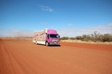 The Purple Truck mobile dialysis unit travels on an outback red dirt road in the Northern Territory.