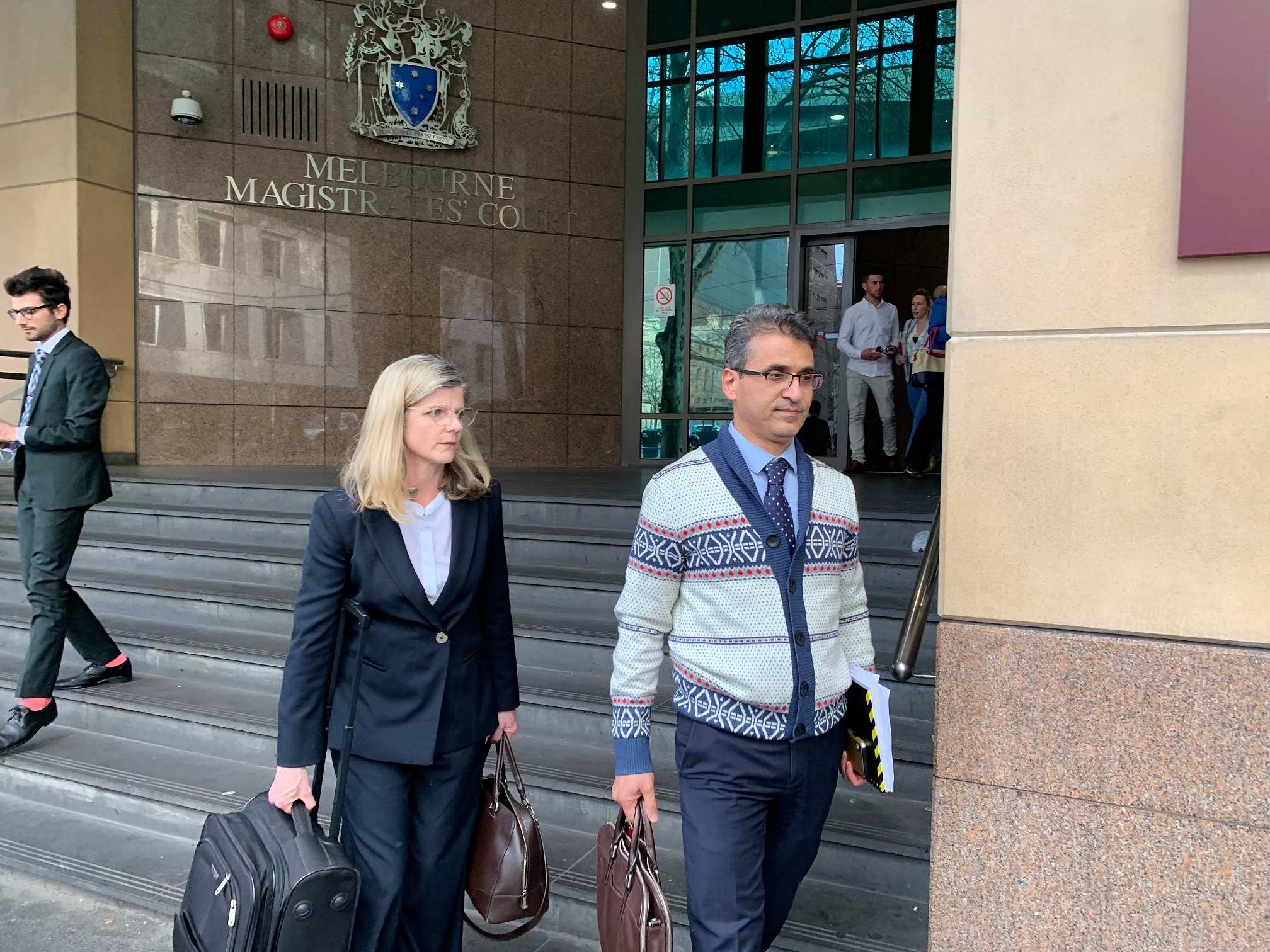 Seyyed Ali Farshchi, wearing a patterned cardigan, leaves the Melbourne Magistrates Court.
