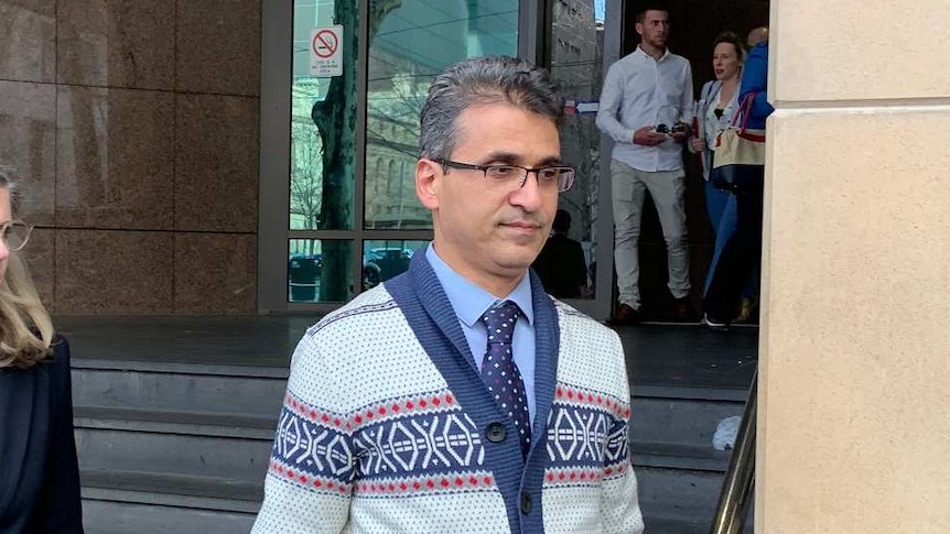 Seyyed Ali Farshchi, wearing a patterned cardigan, leaves the Melbourne Magistrates Court.