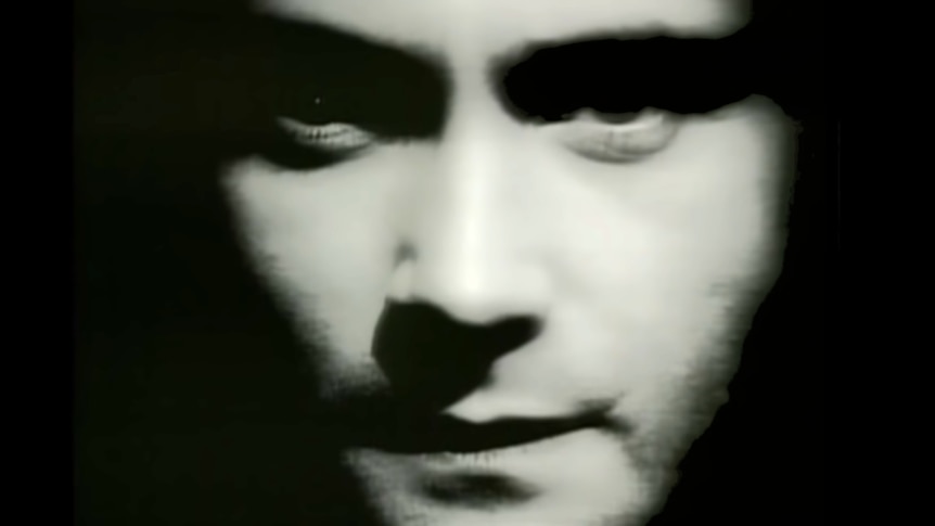 A close up of singer Phil Collins' face.
