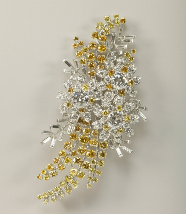 A platinum and diamond brooch in the shape of wattle