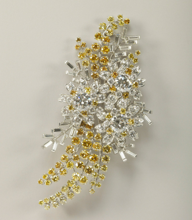 A platinum and diamond brooch in the shape of wattle