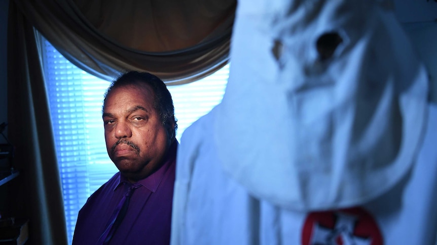 Daryl Davis with a Klan robe given to him by a former member