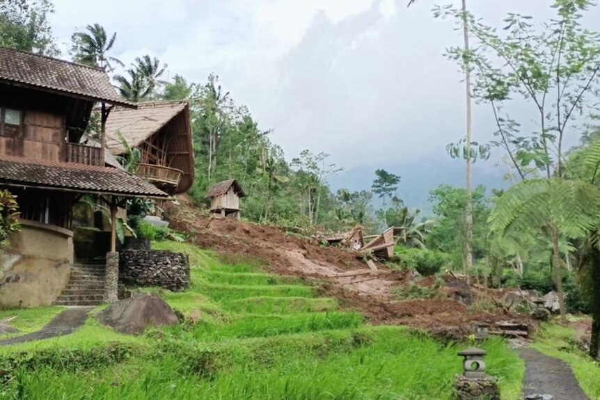 A landslide among Balinese villas in a lush green environment.
