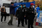 Security guards control access into a community under lockdown in Beijing.
