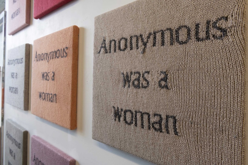 A knitted panel with the words "anonymous was a woman"