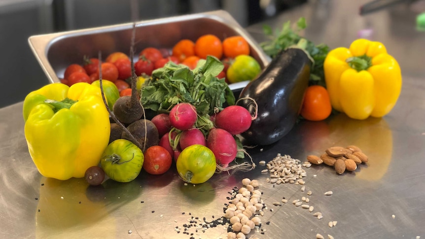 Vegetables sit on a table.