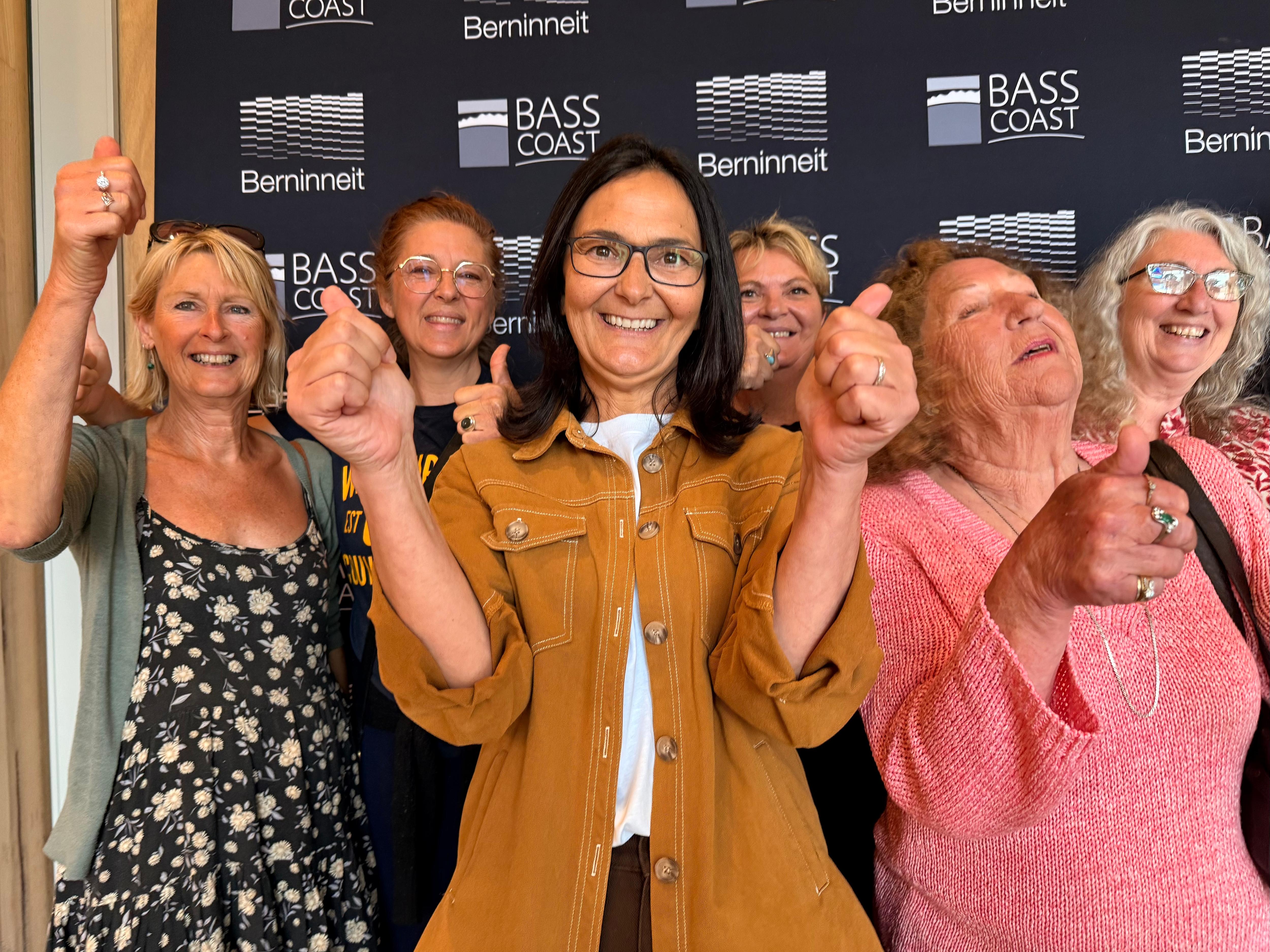 Image of a group of people, happy and with thumbs up.