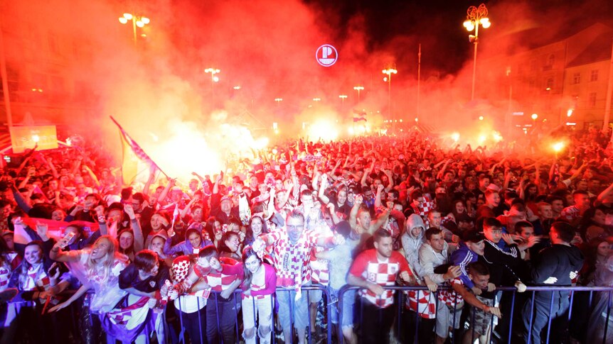 Croatian fans cheer and light flares while watching the semifinal match between Croatia and England