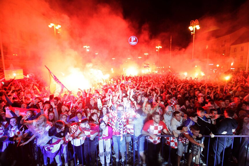 Croatian fans cheer and light flares while watching the semifinal match between Croatia and England