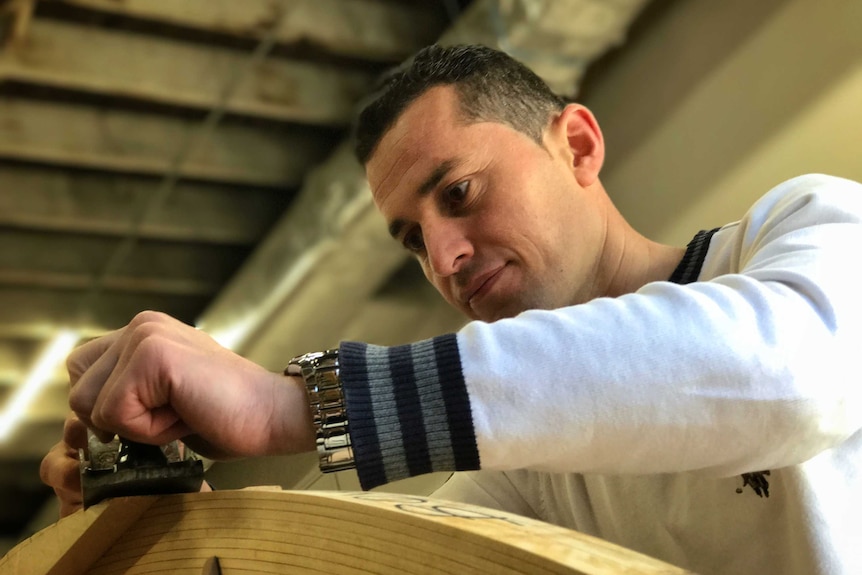 A close-up of a Sordin Habash's face as he works on the refugee skiff at Geelong.