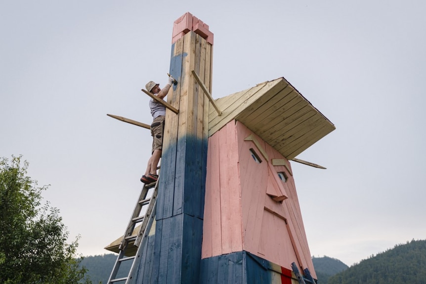 A man works on a wooden statue made to resemble US President Donald Trump in the village of Sela pri Kamniku, about 32 kilometres northeast of Ljubljana in Slovenia3