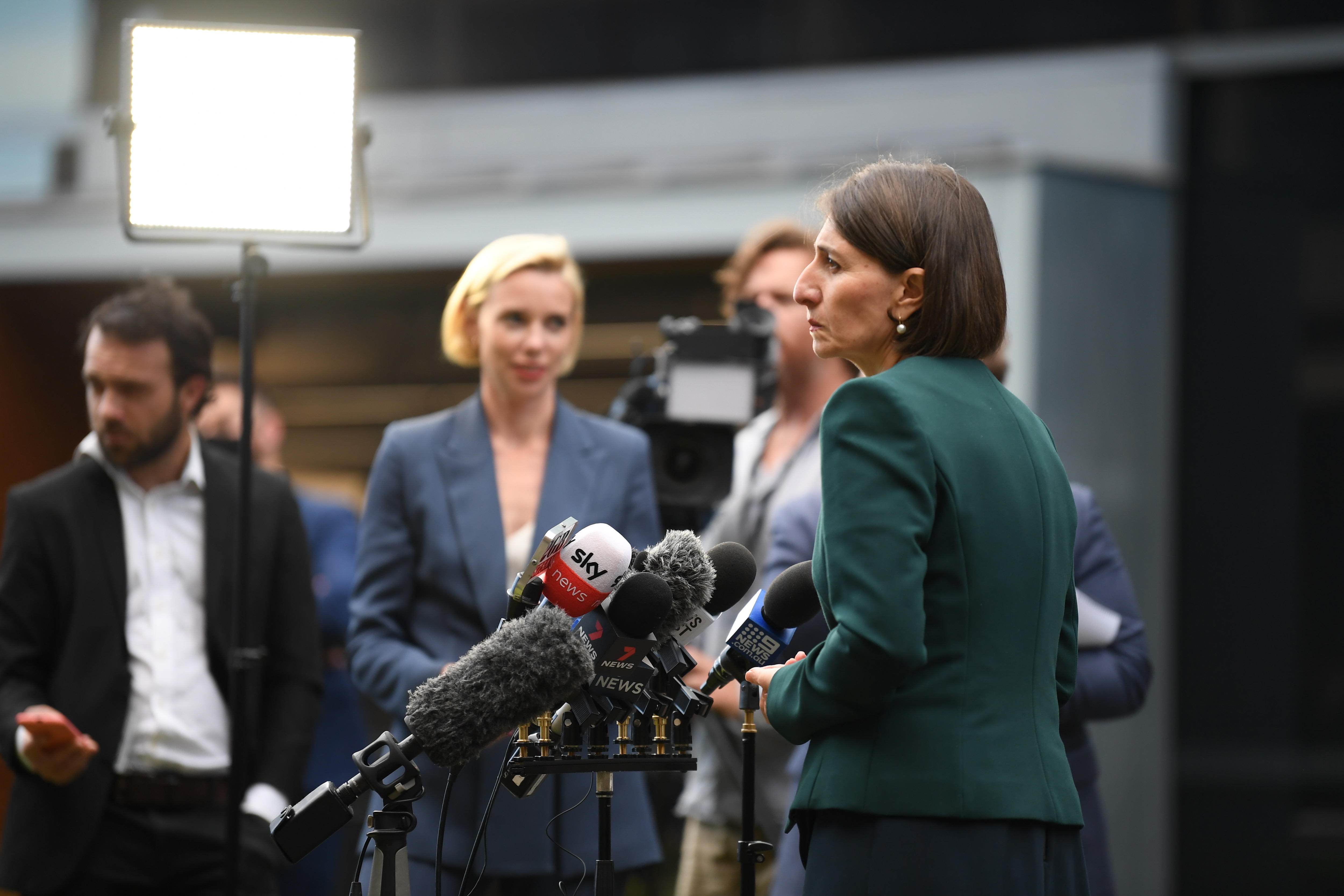 Gladys Berejiklian speaks into microphones to media