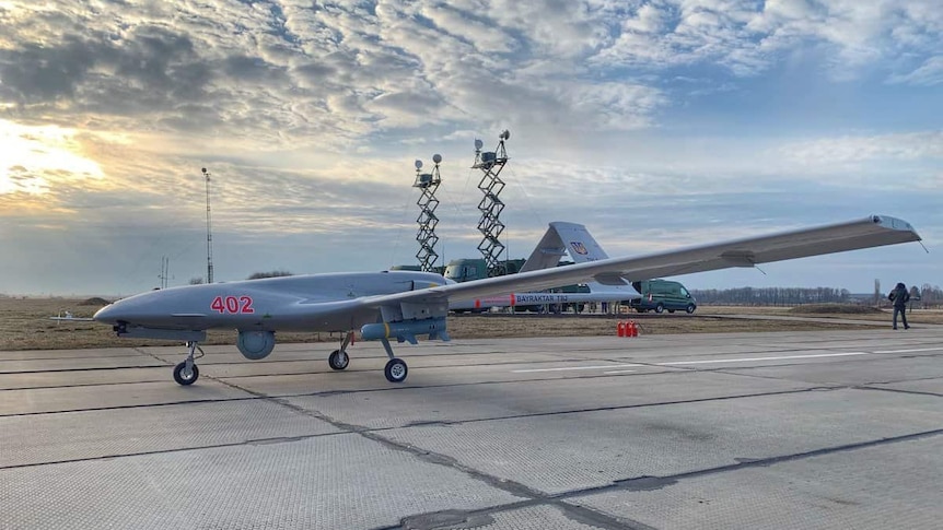 An unmanned drone sitting on a tarmac 