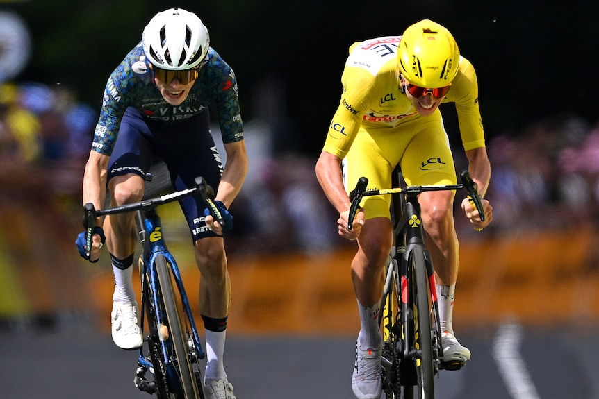 Two cyclist race during a sprint finish in a Tour de France stage.