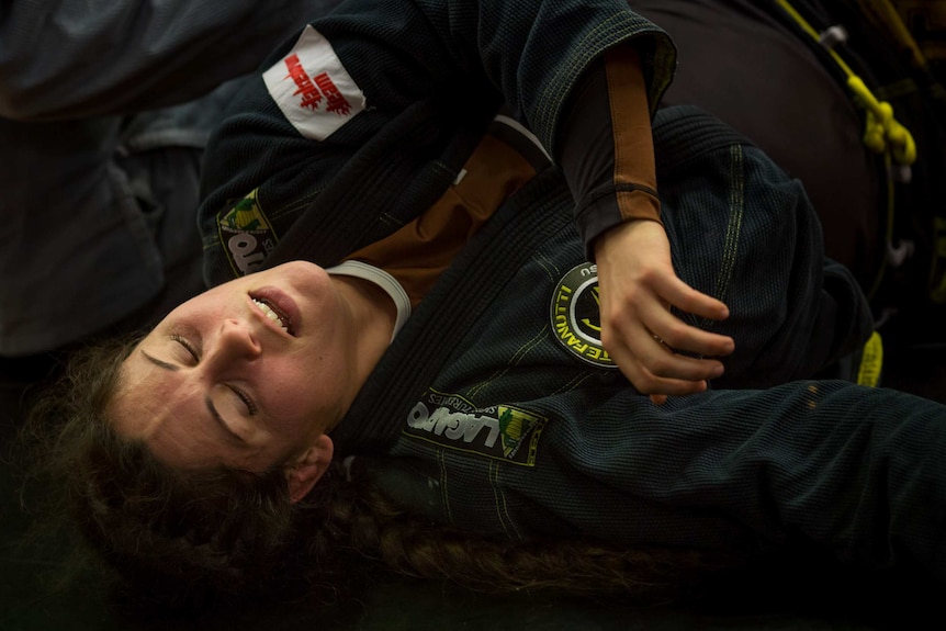 Shantelle Thompson lies on the floor during a fight.