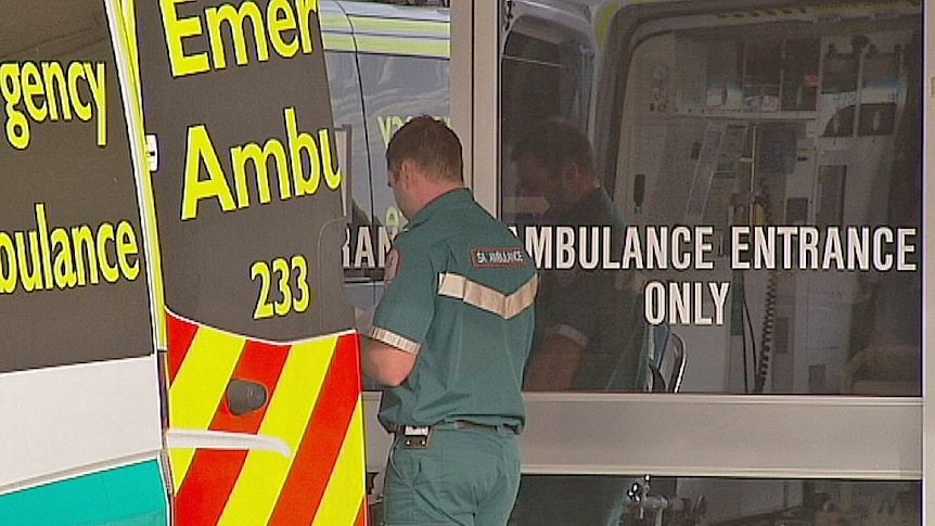 ambulance and paramedics at emergency department entrance
