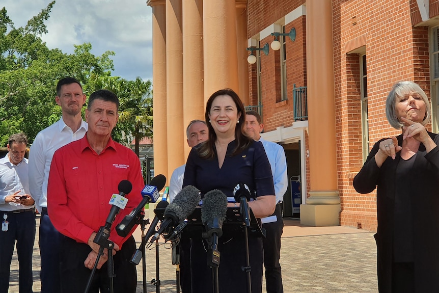 Annastacia smiles at the media conference, surrounded by her colleagues.