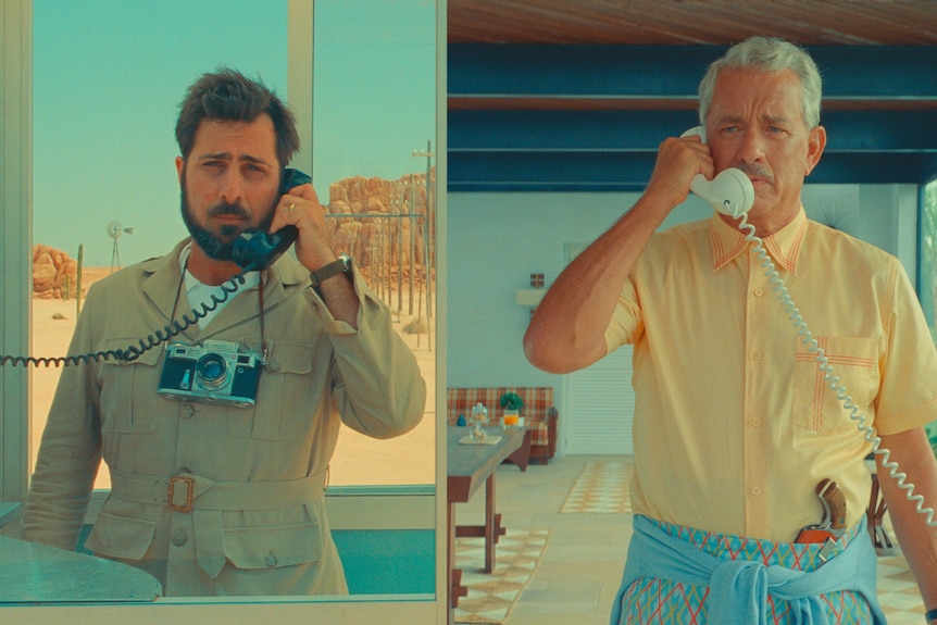 A split screen image of Jason Schwartzman, a brunette white man, and Tom Hanks, a grey-haired white man, talking on the phone.