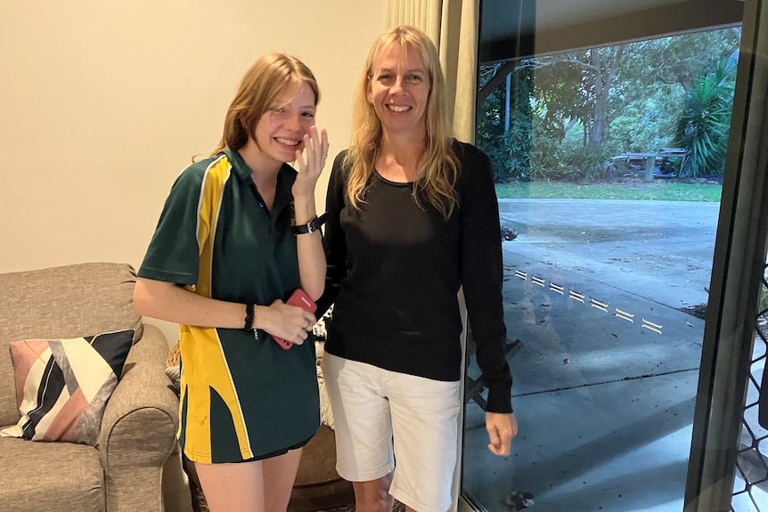 Woodwark resident Tara Rudd standing next to her daughter Jasmin in the family's living room